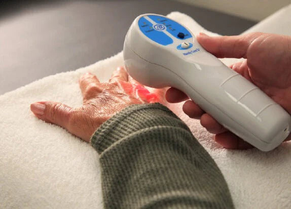 Cold laser therapy being applied to fingers