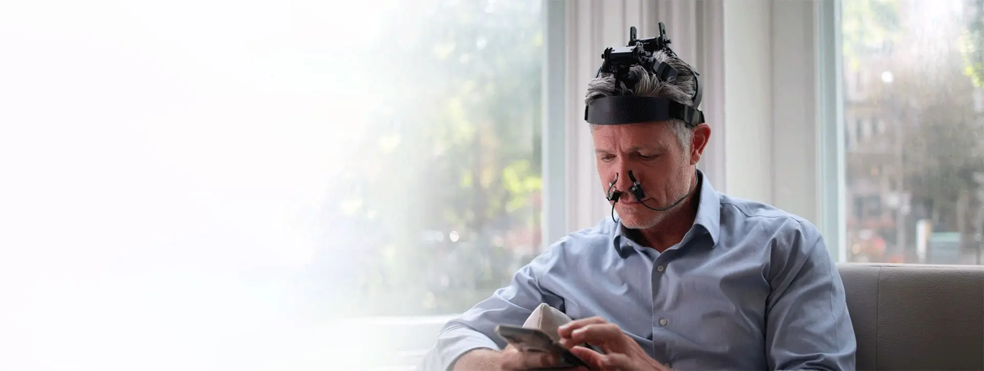 Man wearing Vielight Neuro headset at home for brain photobiomodulation therapy